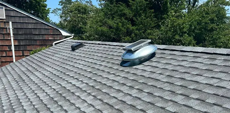 View from atop a single story home's rooftop and tile shingles.